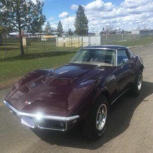 Corvette car sitting in a parking lot.